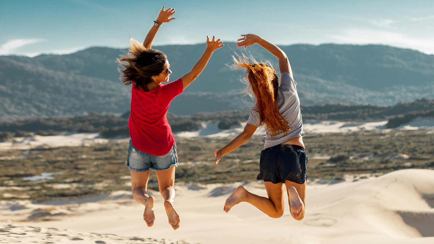 jump shot photography of two women