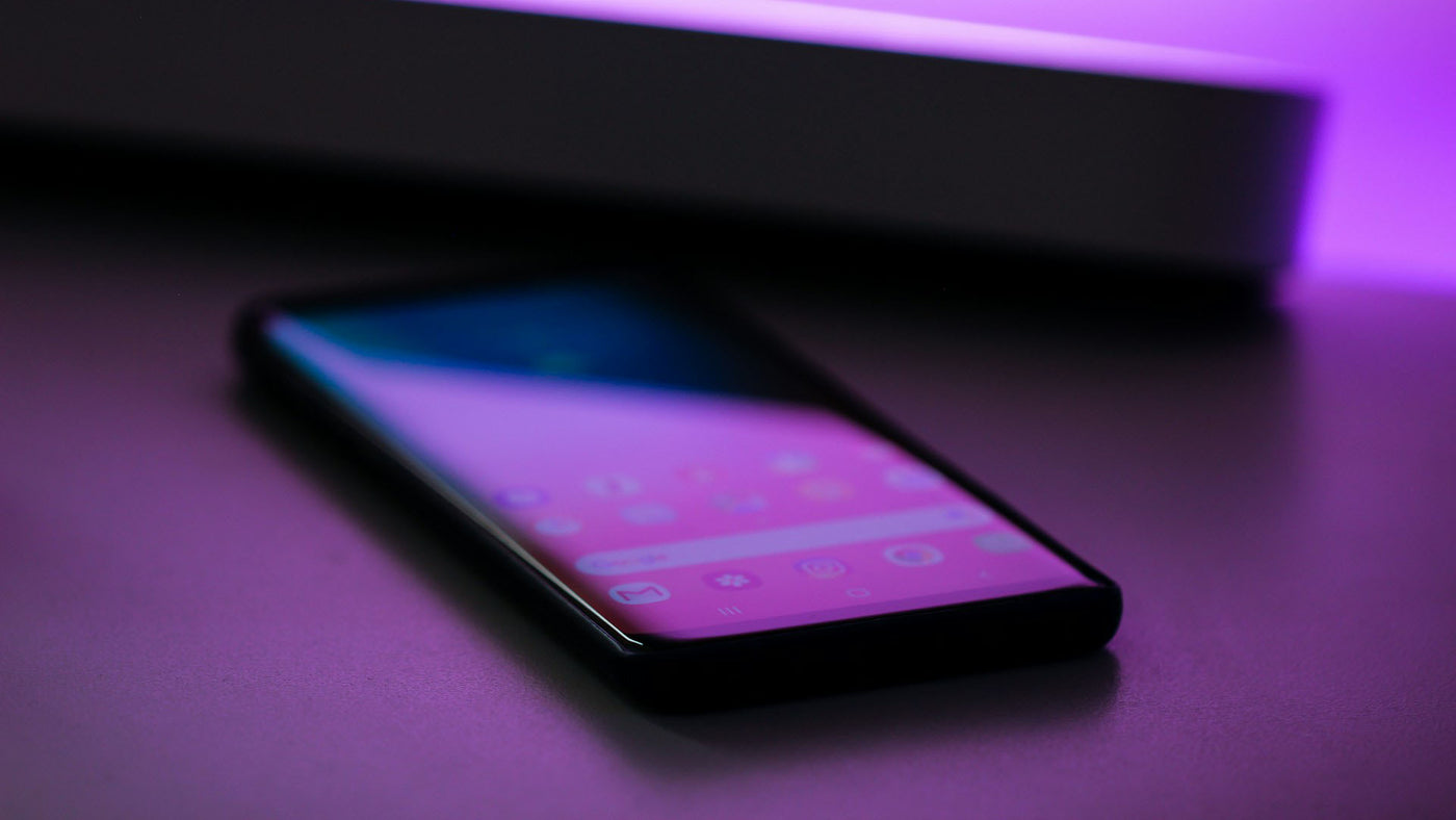 a close-up out of focus shot of a black smartphone