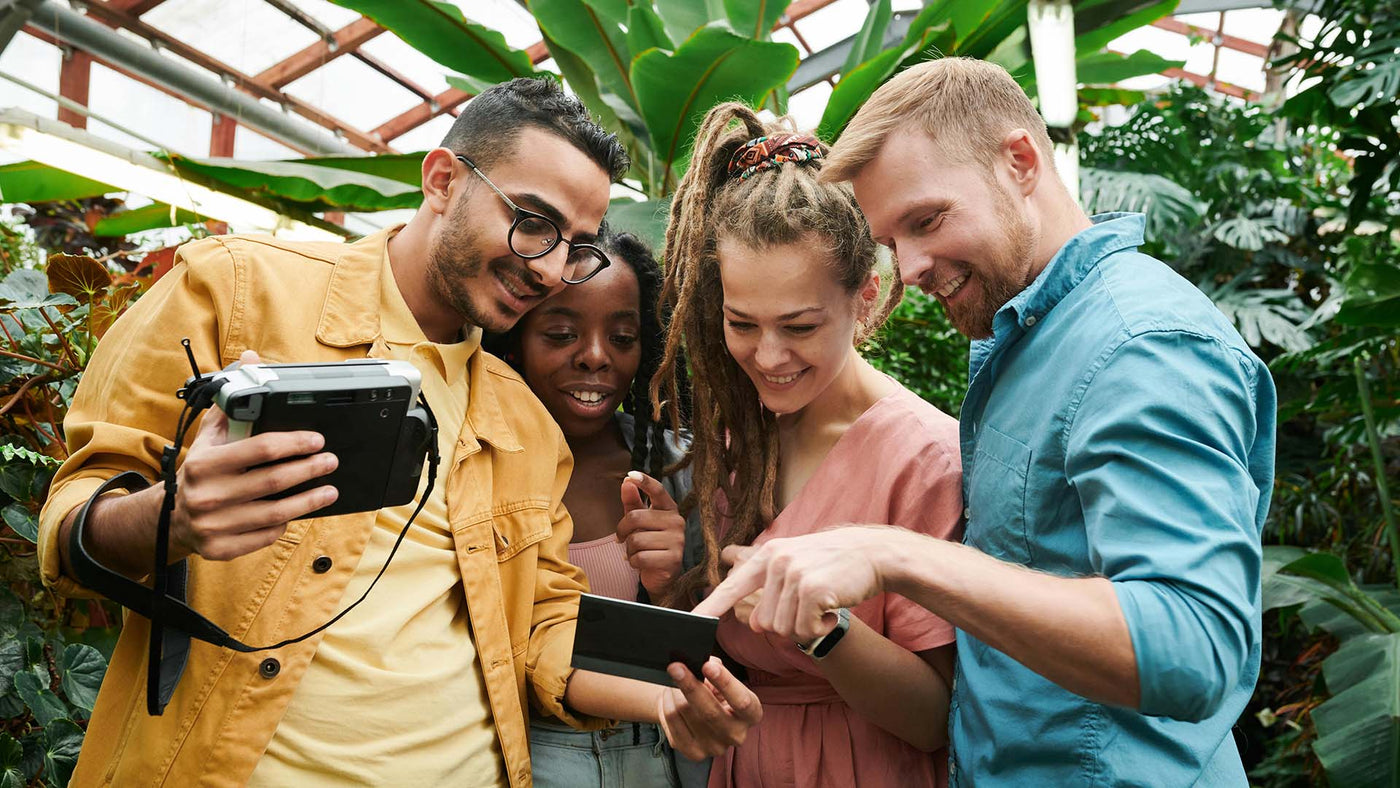 group of friends happily looking at a photograph