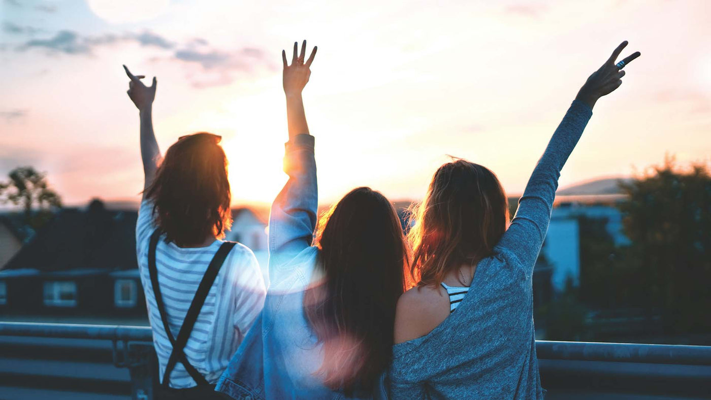 three friends waving their hands