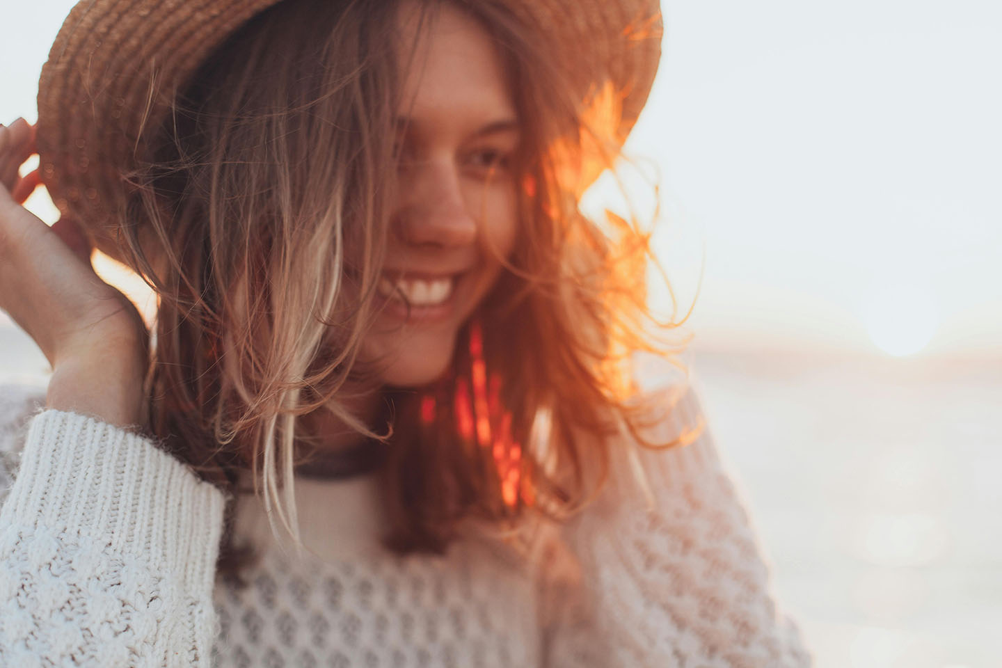 Smiling woman wearing a straw hat