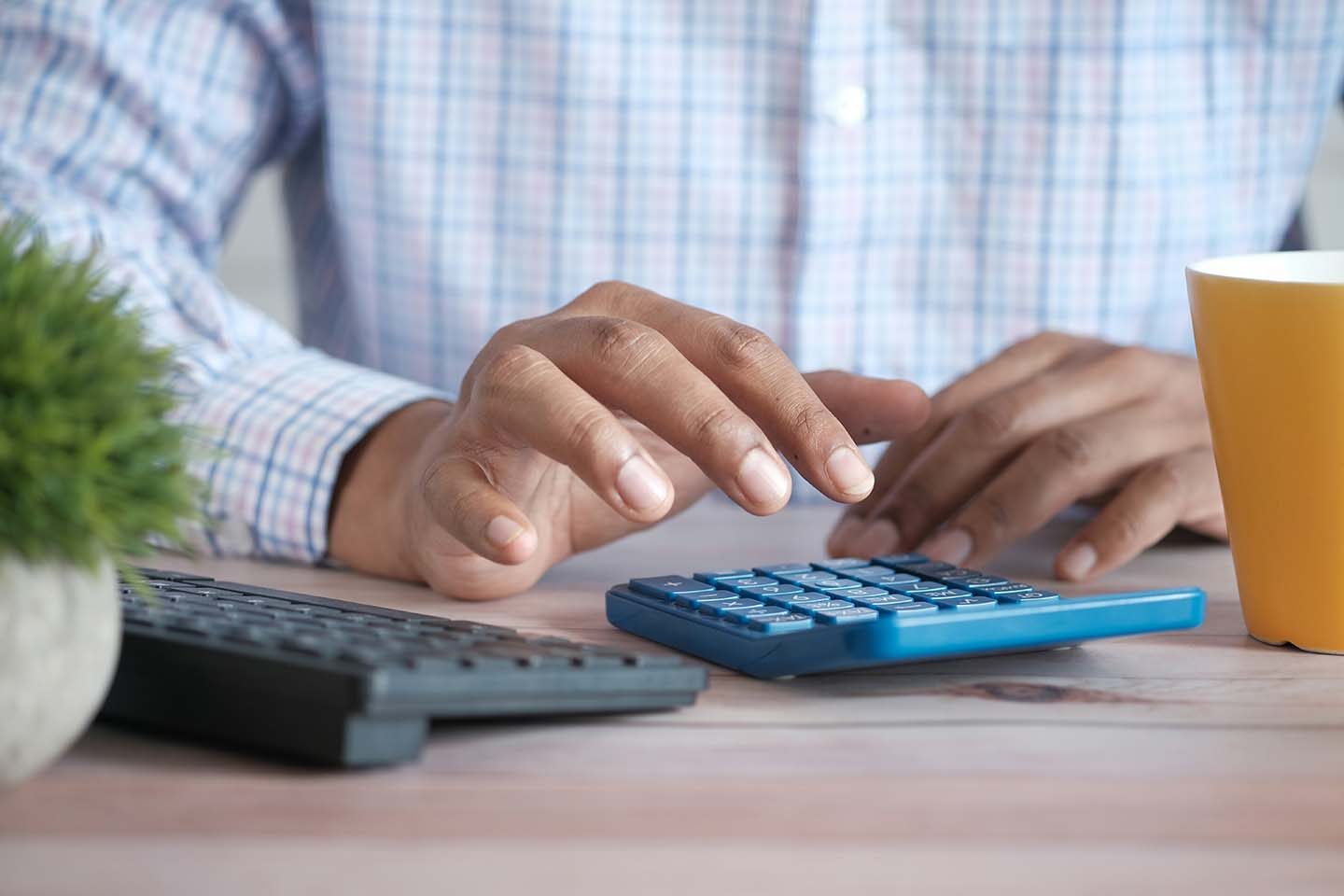 Person using a calculator at a desk