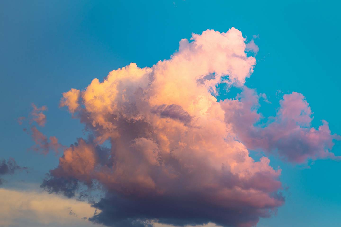 Pink clouds against a blue sky