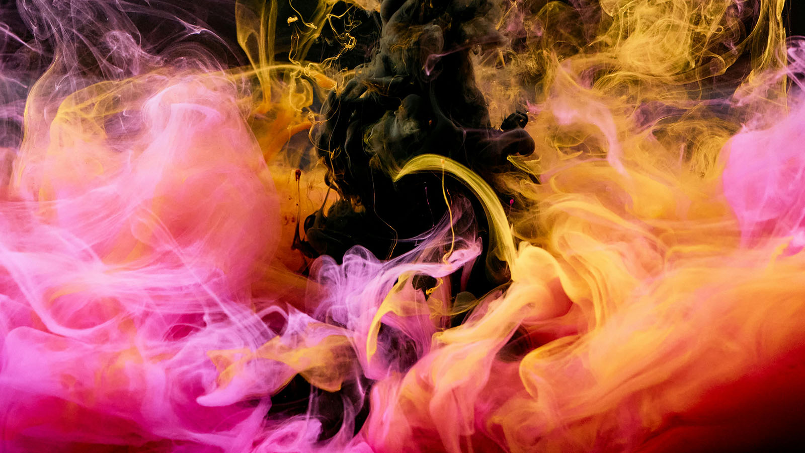 Colorful smoke against a black background