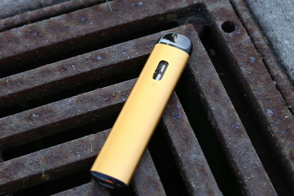 Yellow disposable vape on metal grates